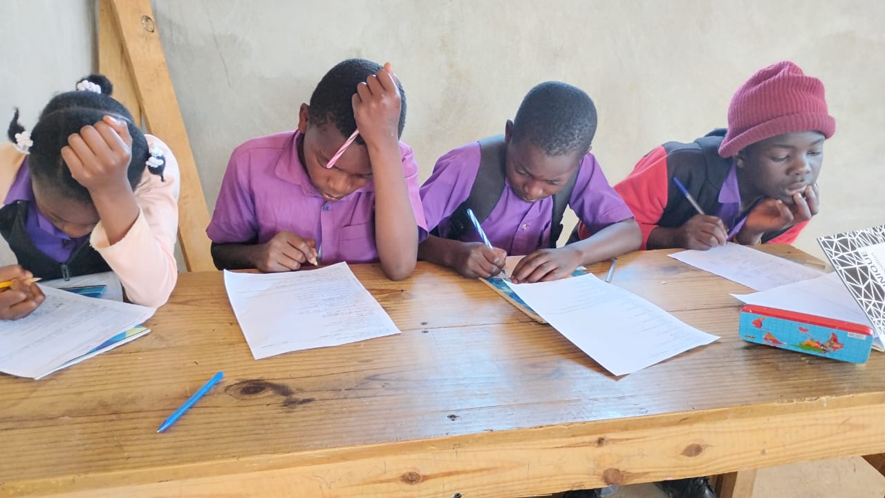 Students working at their desks at Gospel Haiti School